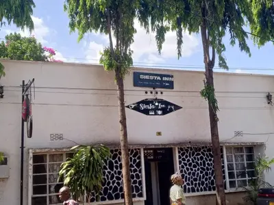 a street sign in front of a building at New Siesta Inn in Nkunjila
