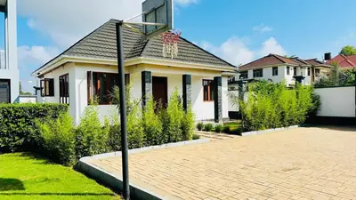 a basketball hoop in front of a house at Small White House Njiro in Arusha