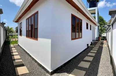 a side view of a white building with windows at Small White House Njiro in Arusha