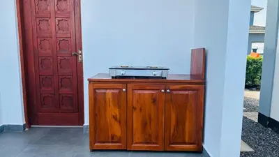 a stove on top of a wooden cabinet next to a door at Small White House Njiro in Arusha
