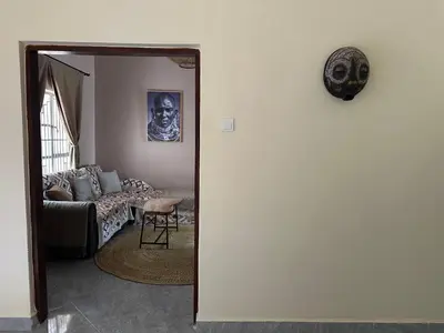 a living room with a couch and a mirror at Meru Nest Arusha Bed & Breakfast in Arusha