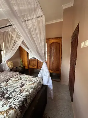 a bedroom with a bed with a canopy at Meru Nest Arusha Bed & Breakfast in Arusha