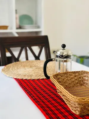 a basket and a glass jar on a table at The Manor Garden House - Arusha Eight-Minute City Stay in Arusha