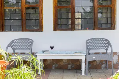 two chairs and a table on a patio at The Manor Garden House - Arusha Eight-Minute City Stay in Arusha
