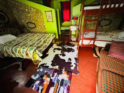 a room with two bunk beds and a rug at Oldadai Falls Retreat in Arusha