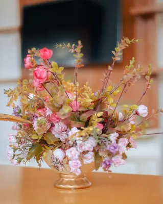 a vase filled with flowers on a table at Arusha Oasis Executive Residence in Arusha