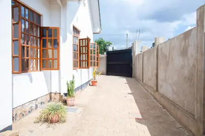 an alley with potted plants on the side of a house at Arusha Oasis Executive Residence in Arusha