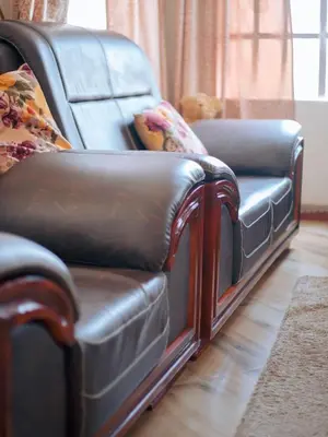 a leather couch and chair in a living room at Arusha 2bedroom in Arusha
