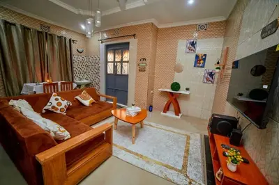 a living room with a couch and a table at Zaal stays in Arusha