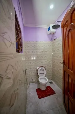a small bathroom with a toilet in a room at Zaal stays in Arusha
