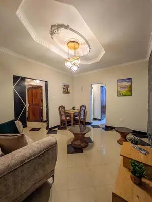a living room with a couch and a table at Joy Land Stay in Arusha