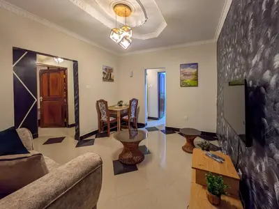 a living room with a couch and a table at Joy Land Stay in Arusha