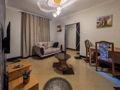 a living room with a couch and a table at Joy Land Stay in Arusha