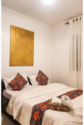 two beds sitting next to each other in a room at Sunset Quarters in Arusha