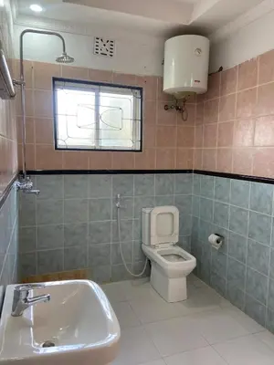 a bathroom with a sink and a toilet at Sunset Quarters in Arusha