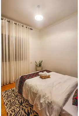 a bedroom with a bed and a potted plant at Sunset Quarters in Arusha