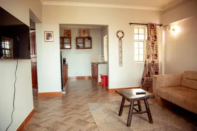 a living room with a couch and a table at Kitopua suites in Arusha
