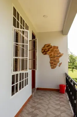 a room with two windows and a door at Kitopua suites in Arusha