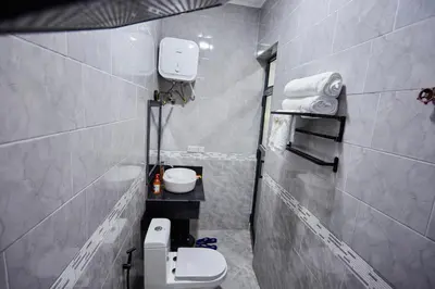 a small bathroom with a toilet and a sink at Njiro Luxury Resort in Arusha