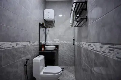 a bathroom with a toilet and a sink at Njiro Luxury Resort in Arusha