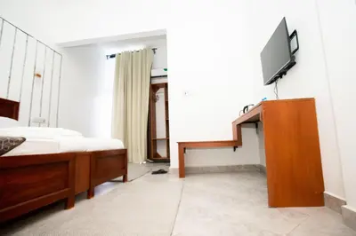 a bedroom with a bed and a flat screen tv at Njiro Luxury Resort in Arusha