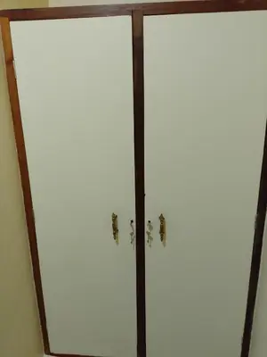 a mirror with two doors in a room at Moshi Roots Homestay in Msaranga