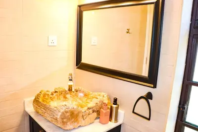 a bathroom with a sink and a mirror at Arcola Residence Machame