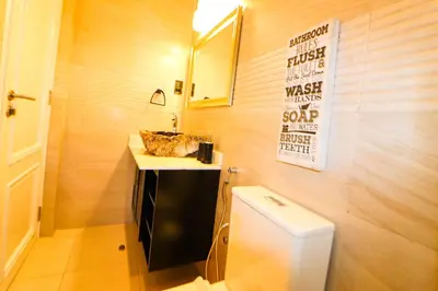 a bathroom with a sink and a toilet at Arcola Residence Machame