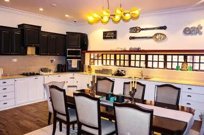 a kitchen with a table and chairs in it at Arcola Residence Machame