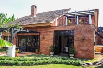 a brick house with a porch and a patio at Arcola Residence Machame