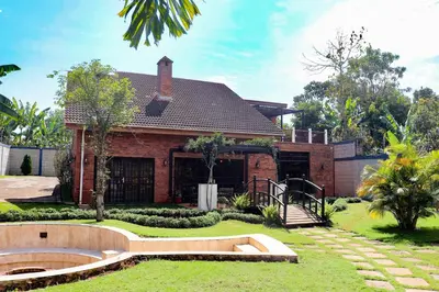 a home with a brick house with a garden at Arcola Residence Machame