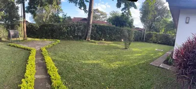 a yard with a hedge and a walk way at Arusha Njiro B&B in Arusha