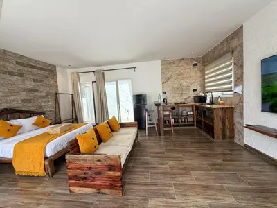 a bedroom with a bed and a couch and a desk at Modern Studio in Njiro, Arusha in Arusha