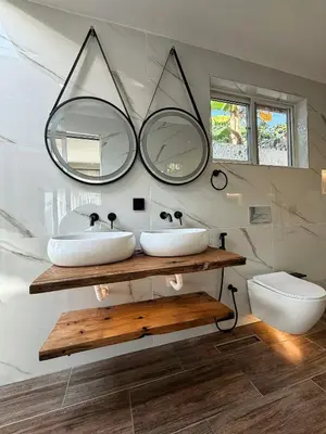 a bathroom with two sinks and a mirror at Modern Studio in Njiro, Arusha in Arusha