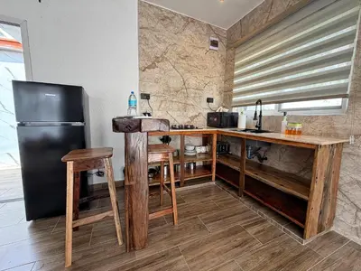 a kitchen with a black refrigerator and wooden counters at Modern Studio in Njiro, Arusha in Arusha