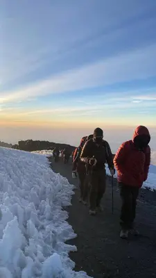 a group of people walking down a snow covered path at Zondela House in Nkoanrua