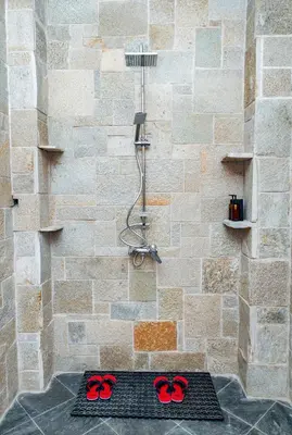 a bathroom with a shower with red scissors on the floor at Zondela House in Nkoanrua