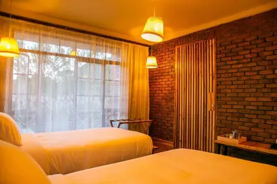 a bedroom with two beds and a window at Zondela House in Nkoanrua