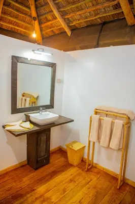 a bathroom with a sink and a mirror at Njiapanda Tented Lodge & Safari in Karatu