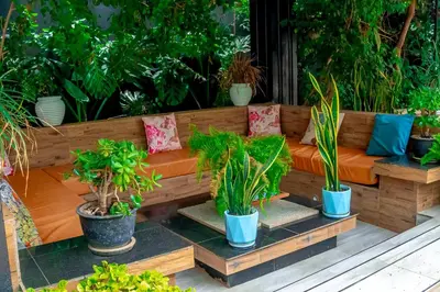 a wooden bench with a bunch of potted plants at Subira Home in Arusha
