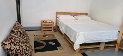 a small bedroom with a bed and a bed sidx sidx sidx at Ruby Cozy Home's in Arusha