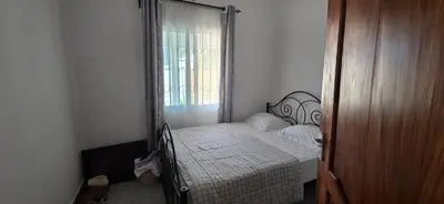 a bed in a room with a window and a bed sidx sidx sidx at Ruby Cozy Home's in Arusha
