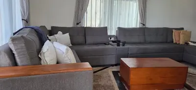 a living room with a couch and a table at Ruby Cozy Home's in Arusha