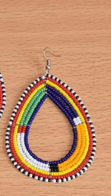 a rainbow colored beaded necklace on a table at Mabegi african Designs in Arusha
