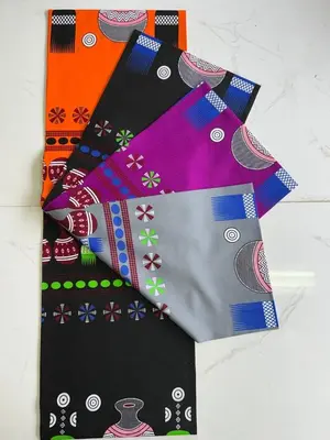 a pile of four different colored ties on a table at Mabegi african Designs in Arusha