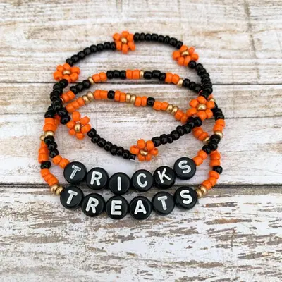a beaded bracelet with orange beads and the words crocs dreams at Mabegi african Designs in Arusha