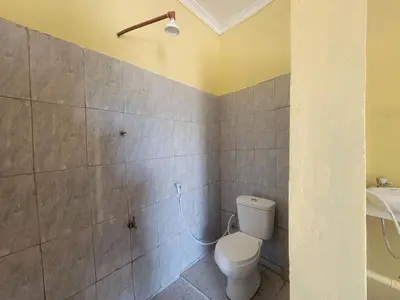 a bathroom with a toilet and a sink at Lengai Maasai homestay in Mtowabaga
