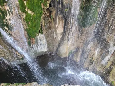 an aerial view of a waterfall on a rock wall at Lengai Maasai homestay in Mtowabaga