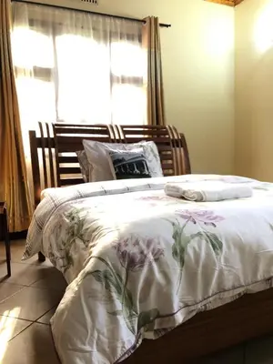 a bedroom with a large bed with flowers on it at Kibebe ataraxia house in Arusha