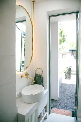 a bathroom with a sink and a mirror at French Unit - 1st floor sleeps 2 in Arusha